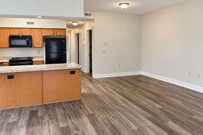 Spiceland apartment for rent - A kitchen with wooden cabinets and a black fridge.