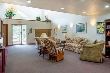 Stevens Point apartment for rent - a living room with couches and chairs and a door