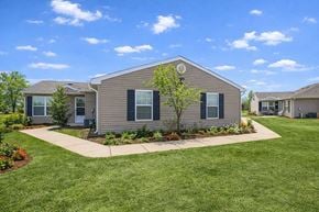 Tulsa apartment for rent - A house with a well-maintained lawn and a clear blue sky.