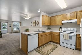 Oshkosh townhouse for rent - A kitchen with a white dishwasher and white stove.
