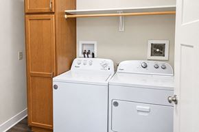 Spiceland apartment for rent - A white washing machine and dryer in a small laundry room.