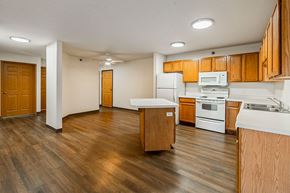 St. Cloud apartment for rent - A kitchen with wooden cabinets and a white countertop.