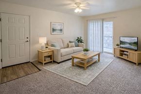 Rifle apartment for rent - A living room with a couch, a coffee table, and a television.