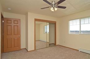 Little Chute apartment for rent - an empty bedroom with a ceiling fan and a mirror