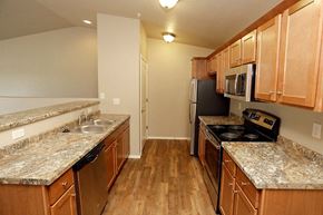 Kronenwetter apartment for rent - A kitchen with wooden cabinets and granite countertops.