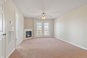 Chatham apartment for rent - A living room with a fireplace and a ceiling fan.