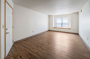 Marshalltown apartment for rent - A room with wooden floors and a window.
