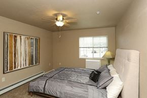 Oshkosh apartment for rent - a bedroom with a bed and a ceiling fan