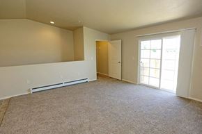 Appleton apartment for rent - an empty living room with a door to a balcony