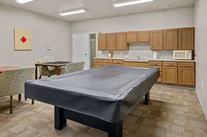 Decatur apartment for rent - A bedroom with a bed, table and chairs.