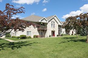 Neenah apartment for rent - a white house with a yard and trees