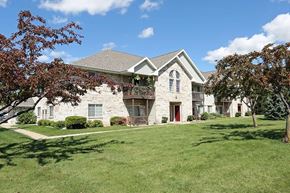 Neenah apartment for rent - a white house with a yard and trees