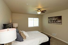 Jackson apartment for rent - a bedroom with a large bed and a ceiling fan