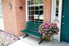 Howard apartment for rent - a green bench sitting in front of a brick building