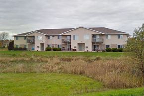Greenville apartment for rent - a large apartment building in front of a green field