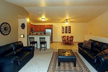 Grafton apartment for rent - a living room with leather couches and a table