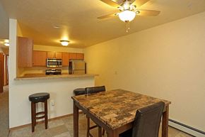 Greenville apartment for rent - a kitchen with a table and chairs and a ceiling fan