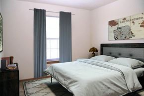 Hutchinson apartment for rent - A bedroom with a large bed and a San Francisco map on the wall.
