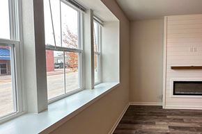 Beaver Dam apartment for rent - A room with a fireplace and a window overlooking a parking lot.