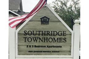 Kasson apartment for rent - a sign townhomes in front of a flag