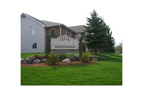 Fitchburg apartment for rent - A sign for Stone Crest Apartments is in front of a building.