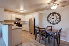 Beaver Dam apartment for rent - A kitchen with a table and chairs and a clock on the wall.