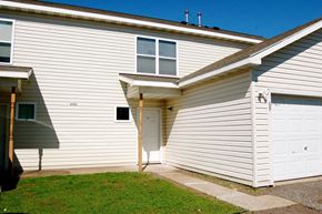 Duluth apartment for rent - A house with a white garage door and a window on the side.