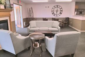 Muskego apartment for rent - A living room with a grey couch, a coffee table, and a fireplace.