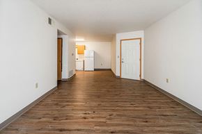 Marshalltown apartment for rent - A room with a wooden floor and white walls.
