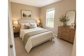 Winfield apartment for rent - A bedroom with a large bed, a dresser, and a mirror.