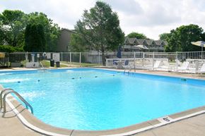Hartland apartment for rent - A large swimming pool with a metal fence around it.