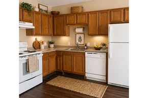 Winfield apartment for rent - A kitchen with wooden cabinets and white appliances.