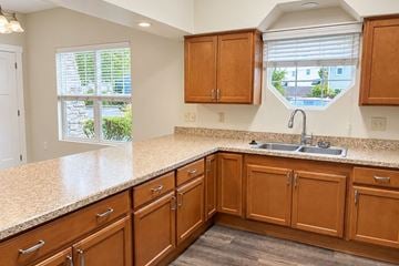 Spiceland apartment for rent - A kitchen with wooden cabinets and a granite countertop.