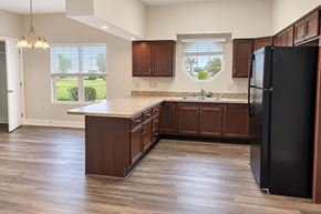 Knightstown apartment for rent - A kitchen with wooden cabinets and a black refrigerator.