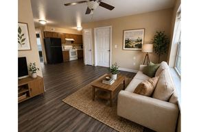 Winfield apartment for rent - A living room with a couch, a coffee table, and a ceiling fan.