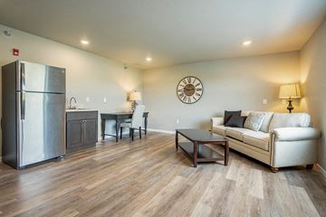 Holmen apartment for rent - a living room with a couch and a refrigerator