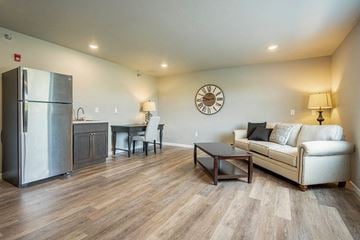 Onalaska apartment for rent - a living room with a couch and a refrigerator