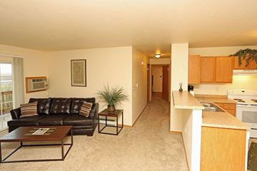 Fond Du Lac apartment for rent - A living room with a brown leather couch and a coffee table.