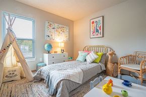 Peoria apartment for rent - a bedroom with a bed and a dresser and a window
