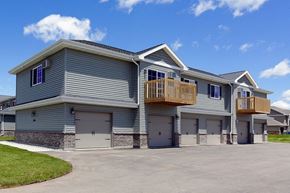 Appleton apartment for rent - a blue house with garage doors and a balcony