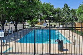 Garden City apartment for rent - A pool surrounded by a black fence with a sign on it.