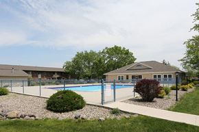 Fond Du Lac apartment for rent - a swimming pool with a fence in front of a house