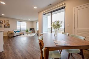 Stewartville apartment for rent - A dining room with a wooden table and chairs.