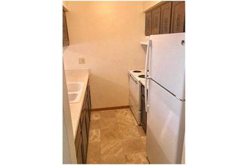 Appleton apartment for rent - a kitchen with a white refrigerator and a sink