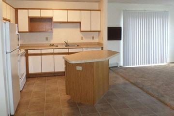 Albert Lea apartment for rent - an empty kitchen with an island in the middle