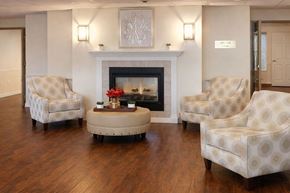 Sumter apartment for rent - A living room with a fireplace and four chairs.