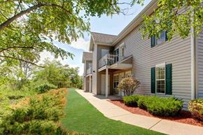 Portage apartment for rent - the front of a house with a sidewalk and grass