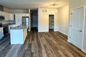 Beaver Dam apartment for rent - A kitchen with a white island and wooden floors.