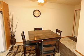 Kiel apartment for rent - a dining room table with chairs and a clock on the wall