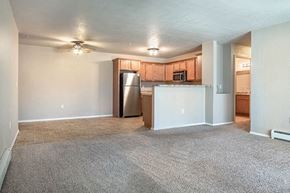 Portage apartment for rent - an empty living room and kitchen with a refrigerator